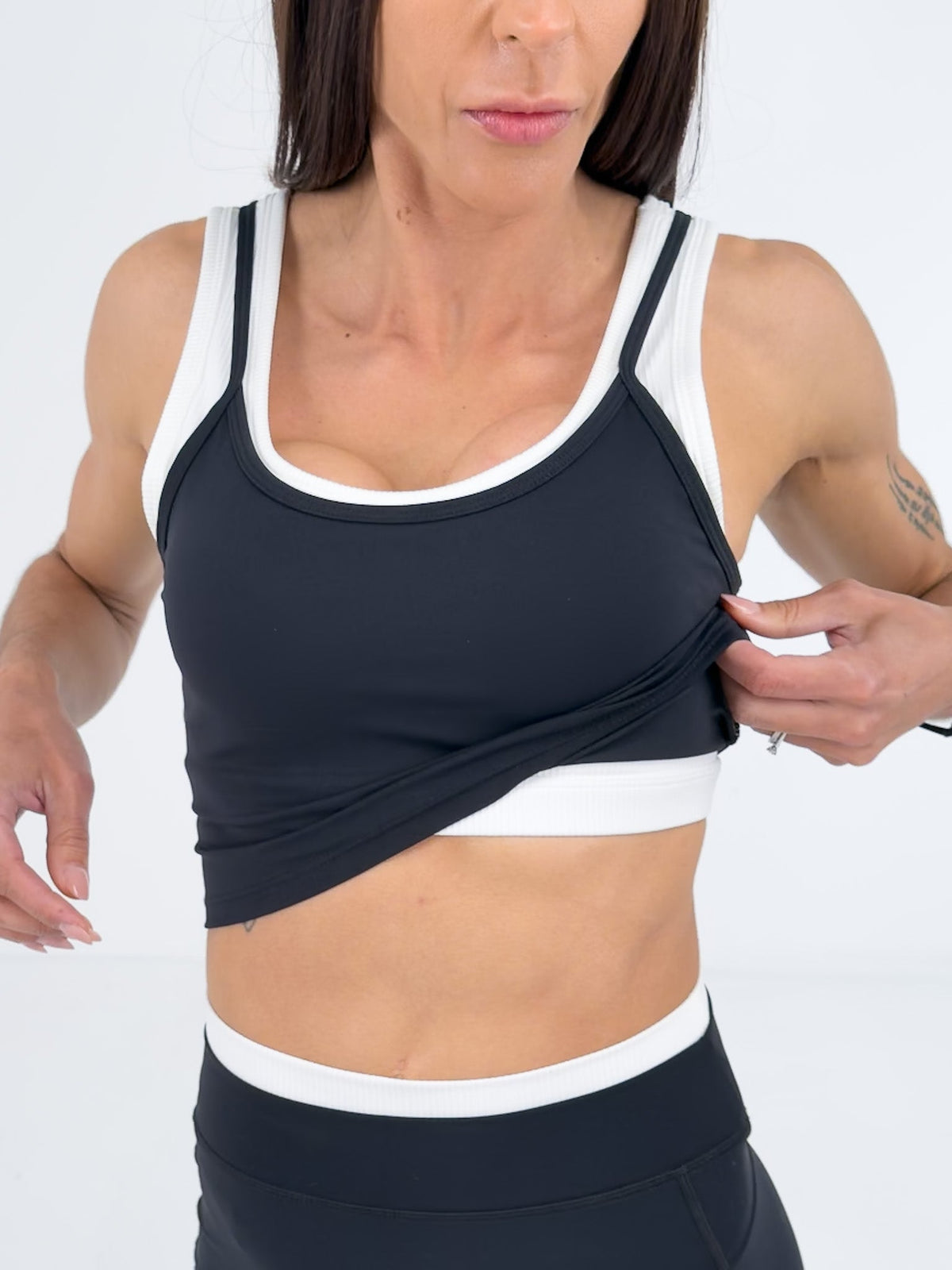 Woman wearing a burgundy athletic outfit on a white background